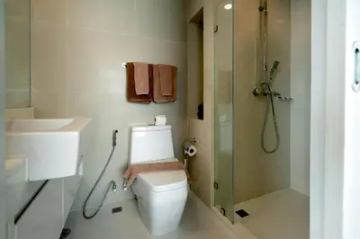 a bathroom with a toilet and a shower and a sink at Aristo 1 Apartments by Beringela in Surin Beach