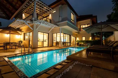 a swimming pool in front of a house at Grand 4-Bed Lagoon Villa - Private Pool & Garden - Laguna in Ban Thalat Choeng Thale