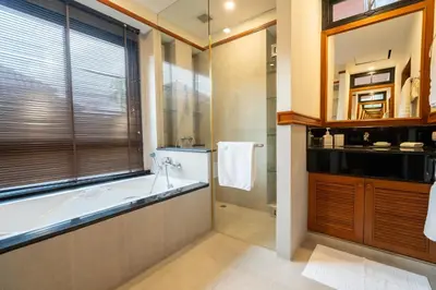 a bathroom with a bath tub and a window at Grand 4-Bed Lagoon Villa - Private Pool & Garden - Laguna in Ban Thalat Choeng Thale