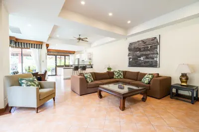 a living room with a couch and a table at Grand 4-Bed Lagoon Villa - Private Pool & Garden - Laguna in Ban Thalat Choeng Thale