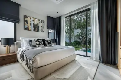 a bedroom with a large bed and a large window at Space villa Botanica Modern Loft in Ban Pak Lak