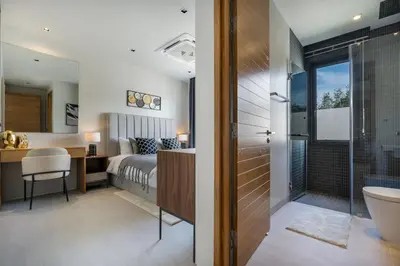 a bedroom with a bed and a bathroom at Space villa Botanica Modern Loft in Ban Pak Lak