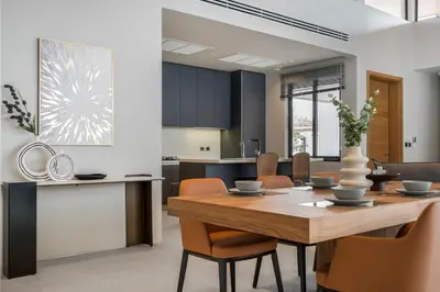 a kitchen and dining room with a wooden table and chairs at Space villa Botanica Modern Loft in Ban Pak Lak