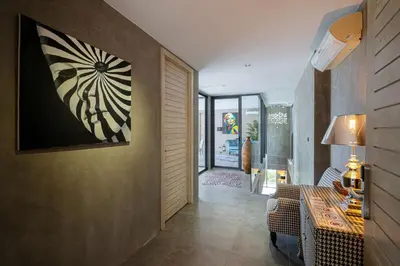 a hallway of a house with a painting on the wall at Serenity and Modern Art - Open Hill View 3BR Natural Park Villa 1 in Kamala Beach