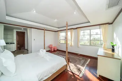 a bedroom with a large white bed and windows at Scenic Seaview Villa Sea Dream for 9, Tennis Court, 5min walk to Kata Noi Beach in Kata Beach