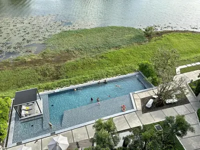 an overhead view of a swimming pool next to a body of water at 2 bedroom Condo at Cassia Laguna in Bang Tao Beach