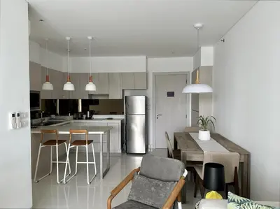 a kitchen with a table and chairs and a kitchen with at 2 bedroom Condo at Cassia Laguna in Bang Tao Beach