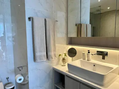 a white bathroom with a sink and a mirror at 2 bedroom Condo at Cassia Laguna in Bang Tao Beach