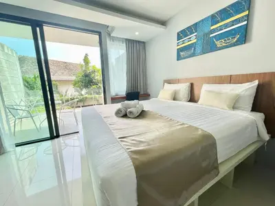 a bedroom with a bed with a teddy bear on it at 1 bedroom near beach - At The Tree in Rawai Beach