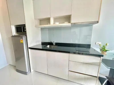 a kitchen with a sink and a refrigerator at 1 bedroom near beach - At The Tree in Rawai Beach