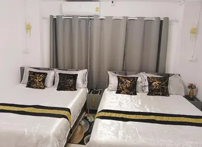 two beds sitting next to each other in a room at STP apartment 3rd floor in Patong Beach