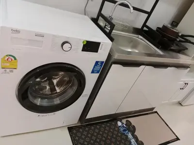 a washing machine sitting next to a sink at STP apartment 3rd floor in Patong Beach