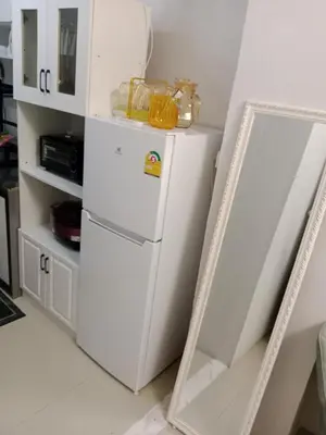 a mirror next to a white refrigerator in a kitchen at STP apartment 3rd floor in Patong Beach
