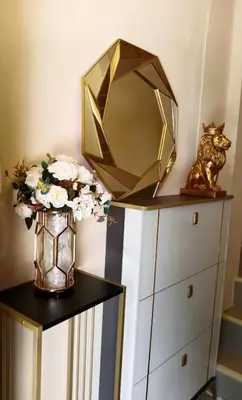 a mirror on top of a dresser with flowers in a vase at STP apartment 3rd floor in Patong Beach