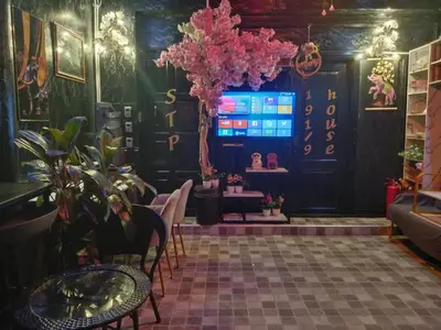 a room with a table and some plants and a screen at STP apartment 3rd floor in Patong Beach