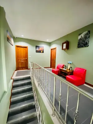a staircase with two red chairs and a table at BT hotel Kata Beach in Kata Beach
