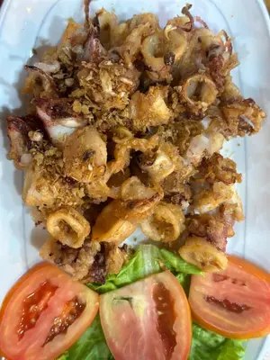 a plate of food with tomatoes and a sandwich at BT hotel Kata Beach in Kata Beach