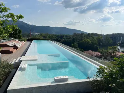 a swimming pool on top of a building at Modern 2-bedroom Apartments with washer in Skypark Laguna Bang Tao in Phuket Town