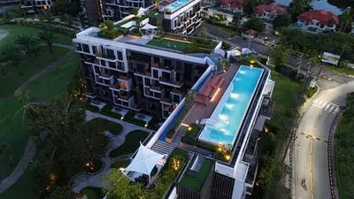 an overhead view of a building with a swimming pool at Modern 2-bedroom Apartments with washer in Skypark Laguna Bang Tao in Phuket Town