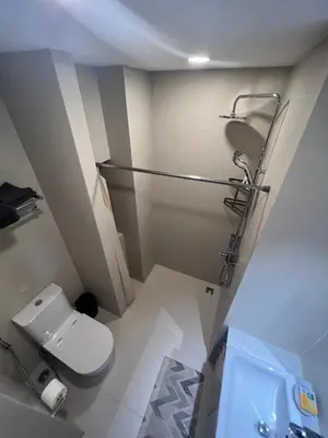 a small bathroom with a toilet and a shower at Modern 2-bedroom Apartments. Skypark Laguna (Bang Tao) in Bang Tao Beach