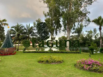 a sign for a park with trees and flowers at Modern 2-bedroom Apartments. Skypark Laguna (Bang Tao) in Bang Tao Beach
