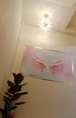 a box with pink wings on a ceiling with a chandelier at STP apartment 2rd floor in Patong Beach