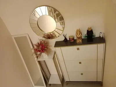 a mirror on the wall above a white dresser at STP apartment 2rd floor in Patong Beach