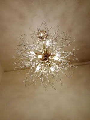a chandelier hanging from the ceiling of a room at STP apartment 2rd floor in Patong Beach