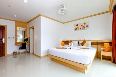 a bedroom with a large white bed in a room at Phusita Hotel - SHA Certified in Patong Beach