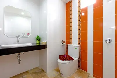 a bathroom with a toilet and a sink at Phusita Hotel - SHA Certified in Patong Beach