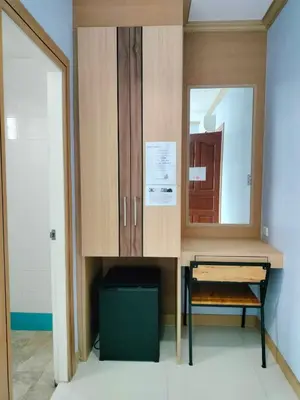 a desk with a mirror and a chair in a room at Phusita Hotel - SHA Certified in Patong Beach