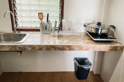 a kitchen counter with a sink and a pot on it at House No.2 Village in Krabi town