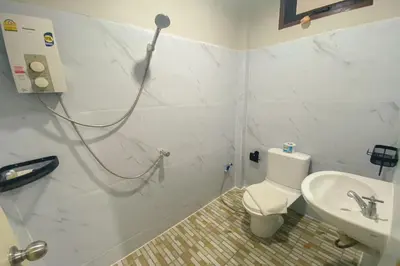 a bathroom with a shower and a toilet and a sink at House No.2 Village in Krabi town