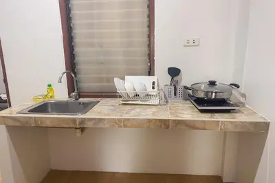 a kitchen counter top with a sink and a counter top at House No.2 Village in Krabi town
