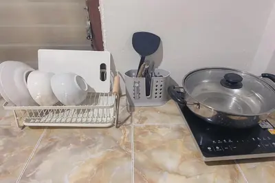 a kitchen counter with a basket of utensils and a sink at House No.2 Village in Krabi town