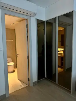 a bathroom with sliding glass doors and a toilet at Cassia Residences in Phuket Town