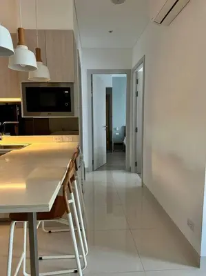 a kitchen with a table and chairs in a room at Cassia Residences in Phuket Town
