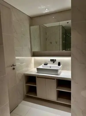 a bathroom with a sink and a mirror at Cassia Residences in Phuket Town