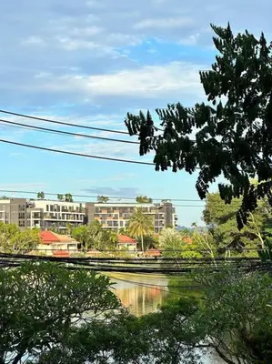 a view of a river with buildings in the background at Cassia Residences in Phuket Town