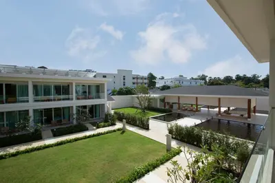 an exterior view of a building with a yard at Niranapa Boutique Resort in Kata Beach