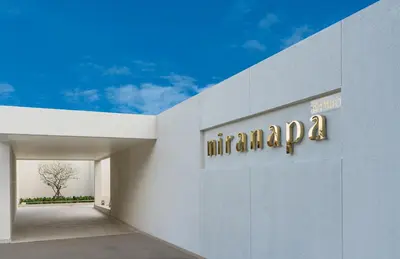 a sign on the side of a building with an amazon sign at Niranapa Boutique Resort in Kata Beach