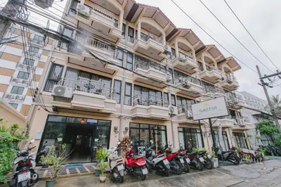 a building with motorcycles parked in front of it at Sunstar Palace Patong in Patong Beach