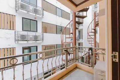 a balcony with stairs in a building at Sunstar Palace Patong in Patong Beach