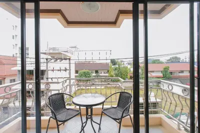 a balcony with a table and chairs and a view at Sunstar Palace Patong in Patong Beach