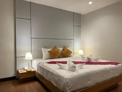 a bedroom with a large bed with two white bowls on it at Zephyr Grand Hotel in Patong Beach