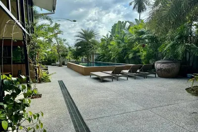 a patio with lounge chairs and a swimming pool at Aonangstudio in Krabi town