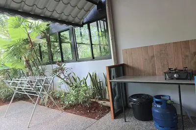 a table and chairs in a room with plants at Aonangstudio in Krabi town