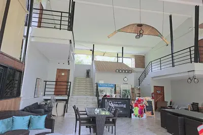 a living room with a staircase and a table and chairs at Aonangstudio in Krabi town