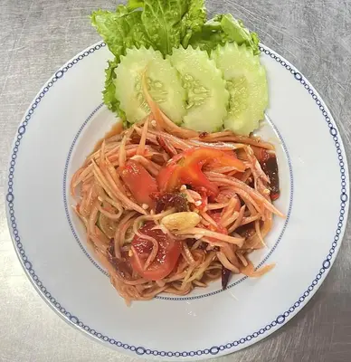 a plate of spaghetti and vegetables on a table at Elephant Sports Bar and Accommodation in Phuket Town