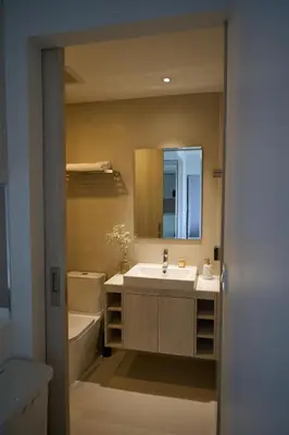 a bathroom with a sink and a tub and a mirror at Modern 2-bedroom Apartments Garden view in Skypark Laguna Bang Tao in Bang Tao Beach